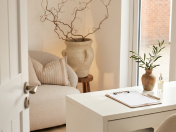 Clean, bright consultation room in an aesthetic clinic featuring a modern desk, neutral decor, and clinical stationery. Clean, bright consultation room in an aesthetic clinic featuring a modern desk, neutral decor, and clinical stationery.